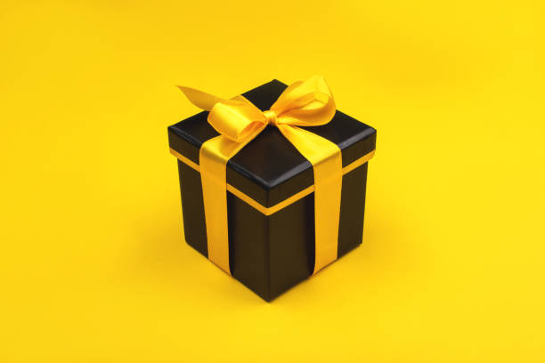 istock One black gift box on yellow background. 1191539620