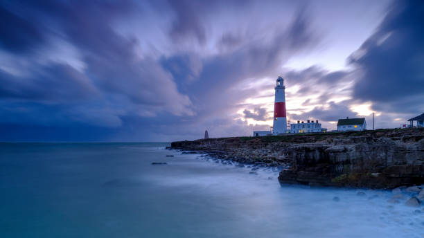istock Portland Bill Light house with a stormy sunset 1191541720