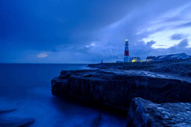 istock Portland Bill Light house with a stormy sunset 1191542293