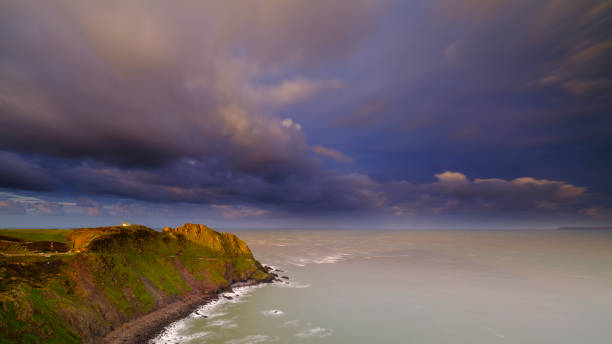 lumière matinale d'heure d'or sur la côte et les falaises près de hartland point - hartland point lighthouse photos et images de collection