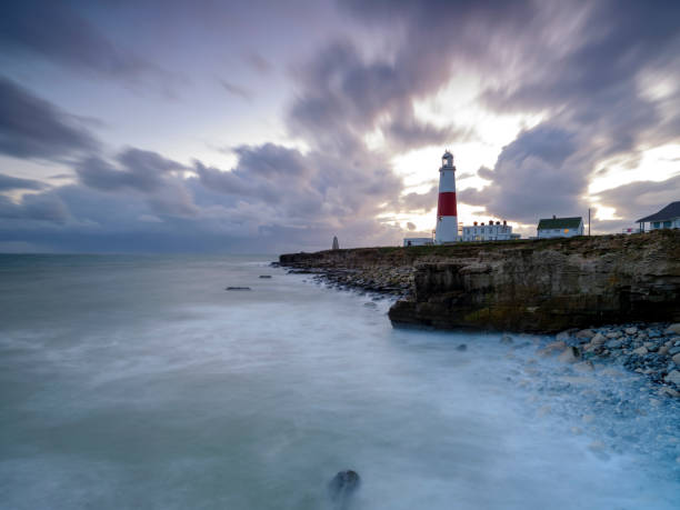 istock Portland Bill Light house with a stormy sunset 1191543143
