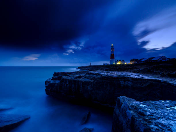 istock Portland Bill Light house with a stormy sunset 1191543190