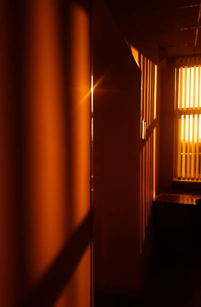 istock Opened vertical blinds at office corridor sunset background 1191543212