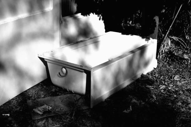 Bathtub in alley waiting for garbage pickup