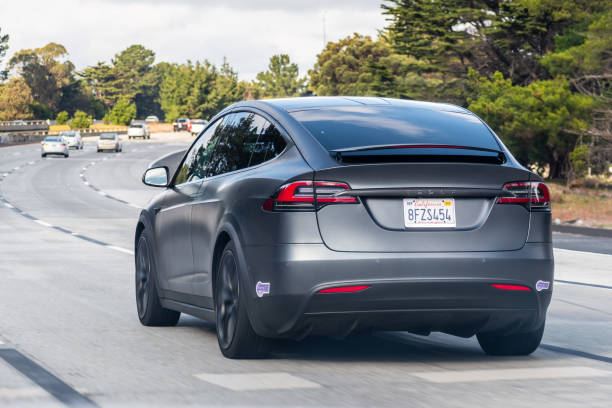 Tesla Model X travelling on the freeway in Silicon Valley Nov 28, 2019 Palo Alto / CA / USA - Tesla Model X travelling on the freeway in Silicon Valley; South San Francisco bay area tesla model x stock pictures, royalty-free photos & images