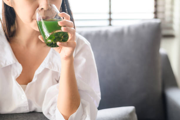 istock drinking healthy green detox juice 1191552786