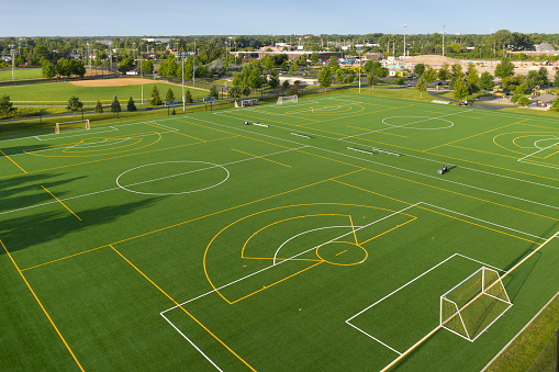 Aerial view of a multi-use playfield with soccer/lacrosse fields and a softball field with lights.
