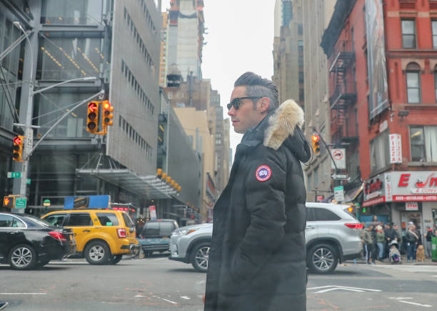 Man with Canada Goose black jacket in New York stock photo