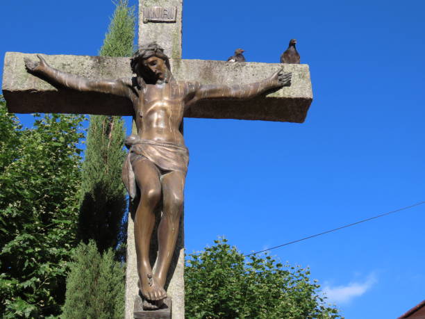istock Christ statue with two pigeons on one side. Background with blue sky 1191562961