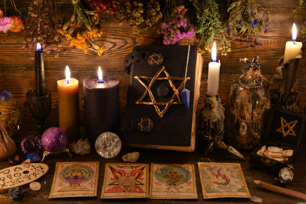 nature morte avec livre de pentagramme, bougie brûlante, pierre précieuse de cristal et cartes de tarot sur la table de sorcière. - wicca photos et images de collection