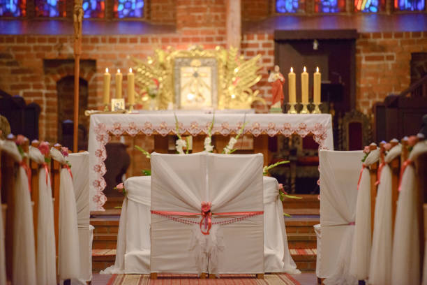 istock Church sanctuary before a wedding ceremony. Empty chairs for bride and groom. 1191563839