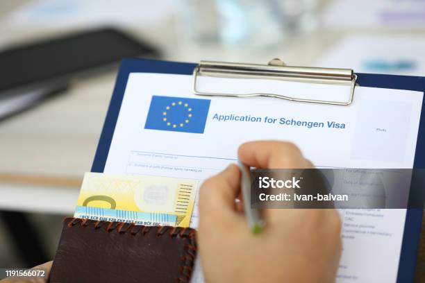 Man Filling Questionnaire Form Stock Photo - Download Image Now - Schengen Agreement, Passport Stamp, Brochure