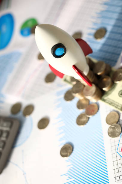 istock White rocket on golden coins 1191566129