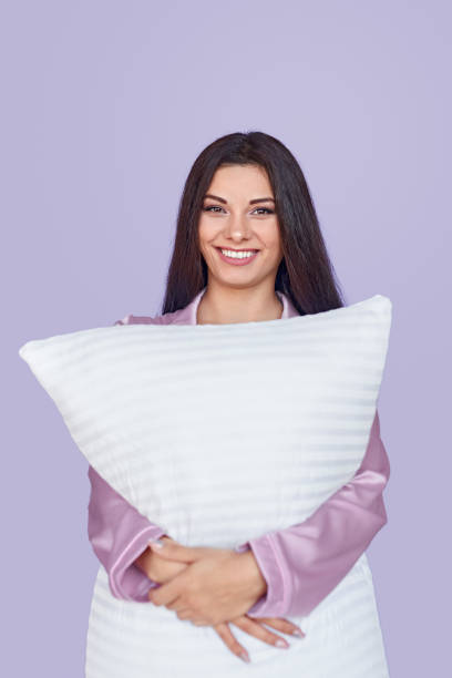 istock Cheerful woman embracing pillow 1191566305