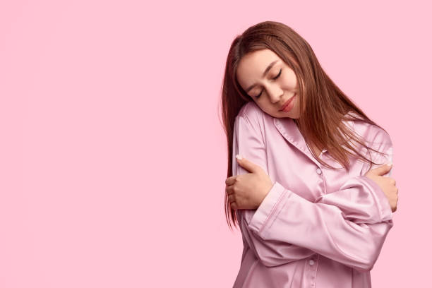 istock Young woman embracing body during sleep 1191566355