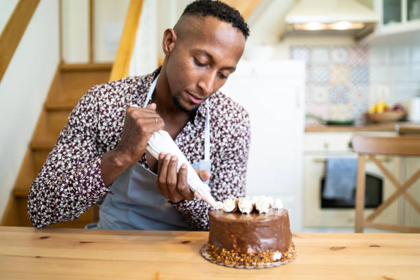 istock African man decorating birthday cake at home 1191566386