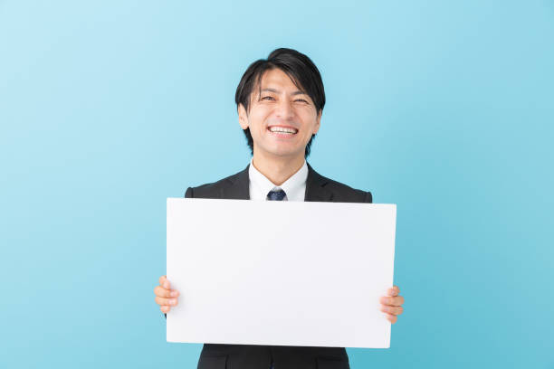 istock businessman holding blank white board, 1191566504