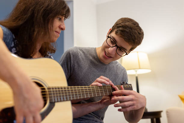 istock Young man giving guitar lessons 1191566539
