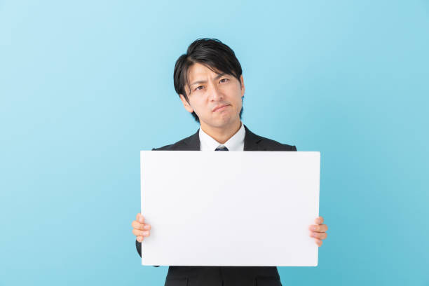 istock businessman holding blank white board,think, 1191566882