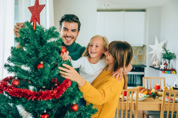 istock Cheerful family decorating the Christmas tree 1191567839