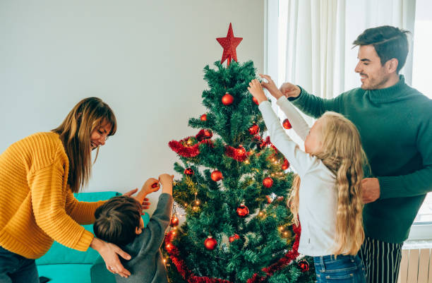 istock Family decorating the Christmas tree 1191567841