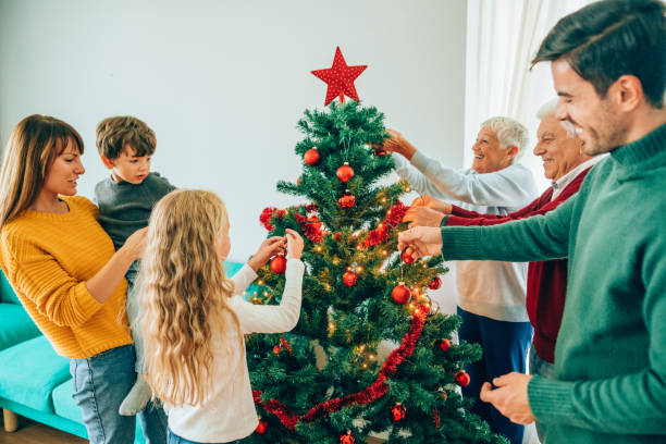 istock Multi-generation family decorating the Christmas tree together 1191567848