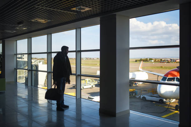 istock Man standing with luggage 1191572613