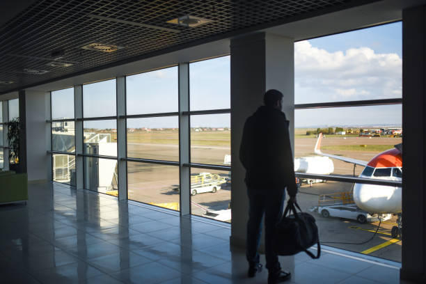 istock Man standing with luggage 1191572666