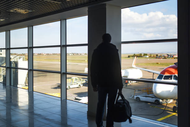 istock Man standing with luggage 1191572747