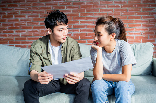 asian young couple discuss about their finance plan including tax and mortgage or investment