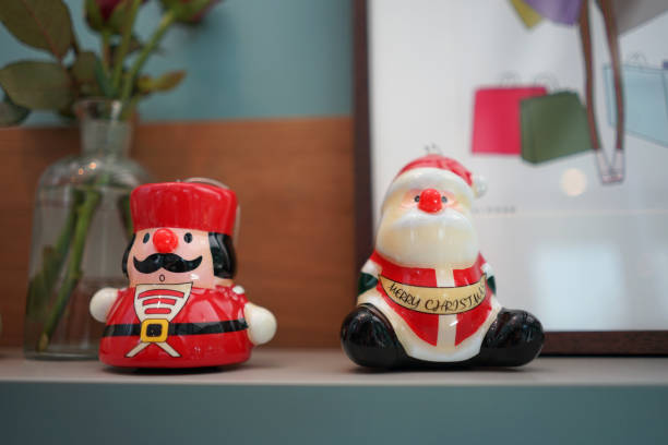 istock Christmas decorative small ceramic doll on timber table 1191575684