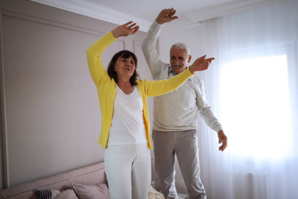 istock Cheerful senior couple jumping on bed 1191581136
