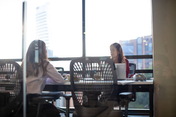 istock Two businesswoman talking about work at the office 1191581449