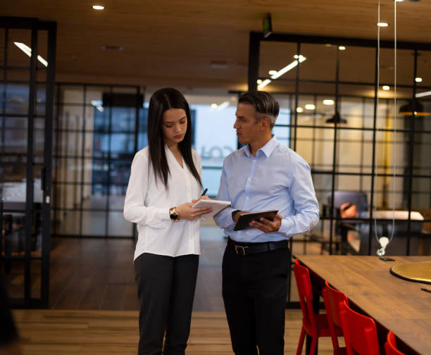 istock Two people discussing something about their work at the office 1191581528