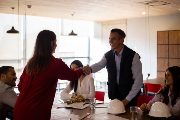 istock Group of architects shaking their hands 1191581576