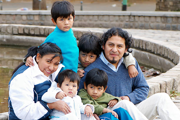Latin family sitting in the street stock photo