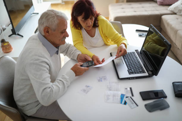 istock Senior couple paying bills at home 1191583747