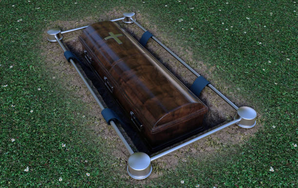 Modern Coffin Into Grave A modern wooden coffin at a funeral being lowered into a grave with a lowering mechanism a dirt and grass background - 3D Render funeral expense stock pictures, royalty-free photos & images