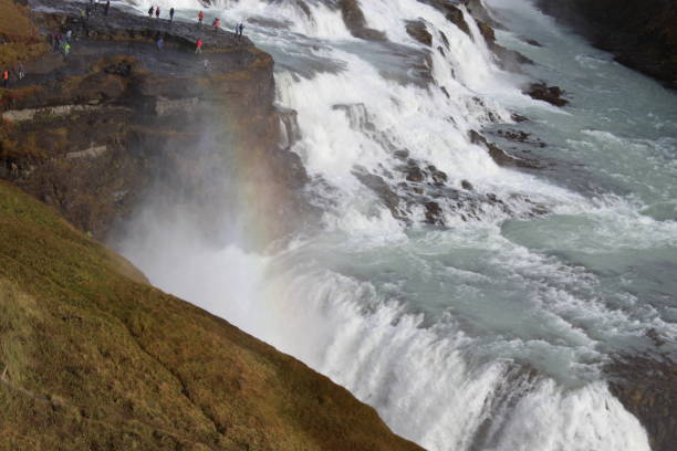 istock waterfall in Iceland with rainbow 1191591360