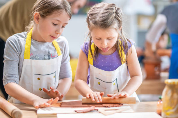 istock Girls rolling clay in classroom 1191592220
