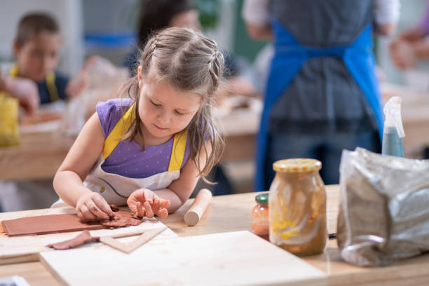 istock Girl making clay birdhouse 1191592222