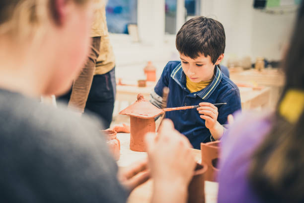 istock Boy making clay birdhouse 1191592239