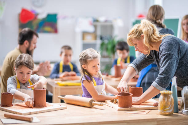 istock Girls making clay birdhouse in classroom 1191593704