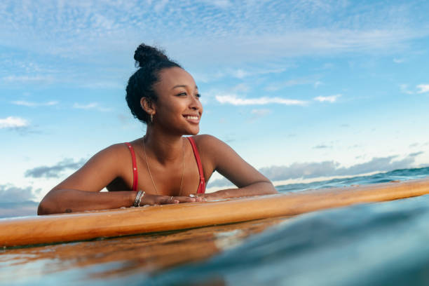 istock Young woman resting on her surfboard waiting for a wave 1191597634