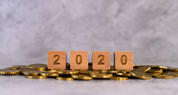istock 2020 word alphabet wooden cube letters placed on a gold coin 1191599059