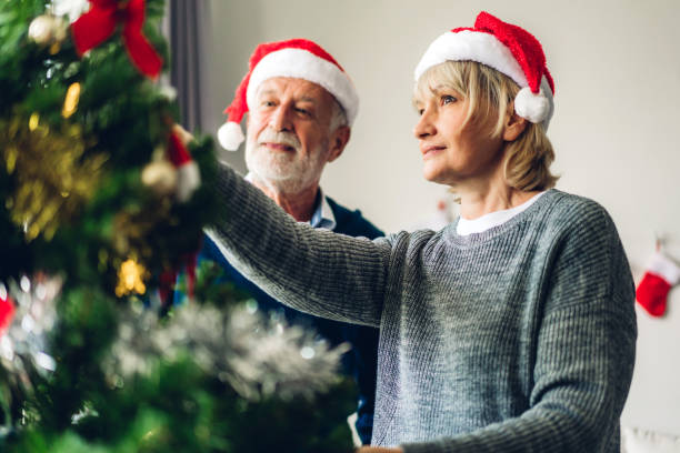 istock Romantic sweet senior couple relaxing  decorating christmas tree and smiling while celebrating new year eve and enjoying spending time together in christmas time at home 1191600236