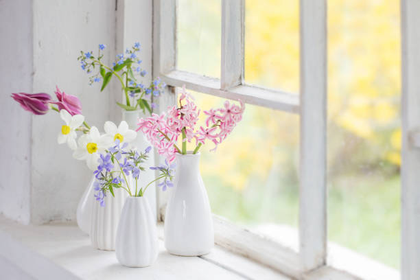 istock spring flowers in white vase on old windowsill 1191600307