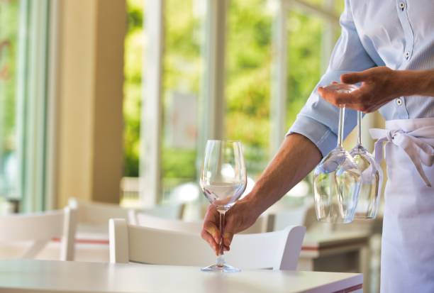 istock Young waiter cleaning fork in restaurant 1191600931