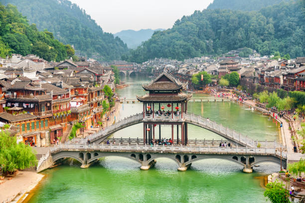 High angle view of scenic bridge in Phoenix Ancient Town Fenghuang, China - September 23, 2017: High angle view of scenic bridge with elements of traditional Chinese architecture in Phoenix Ancient Town. Fenghuang is a popular tourist destination of Asia. fenghuang county photos stock pictures, royalty-free photos & images