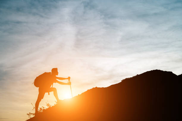 istock One man walked up the hill with his cane. 1191602949